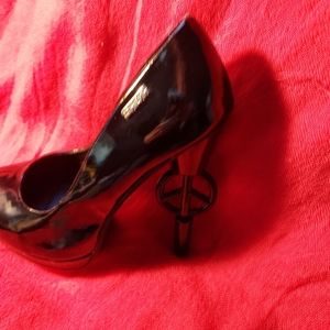 Black patent stilettos with peace symbol in spiked heel